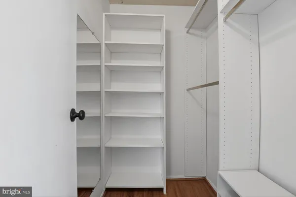 a view of walk in closet with empty racks