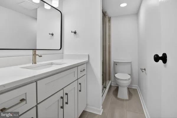 a bathroom with a sink toilet and mirror