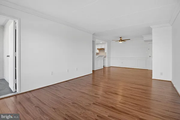 a view of empty room with wooden floor