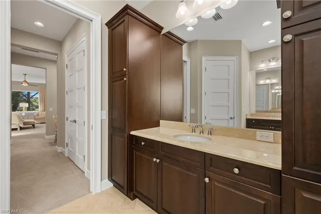 a spacious bathroom with a shower sink and mirror