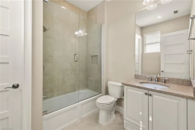a view of staircase with railing and a chandelier