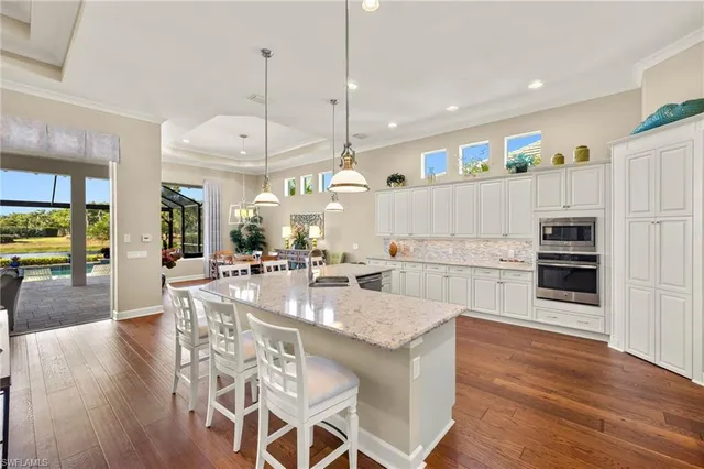 a large kitchen with a table and chairs