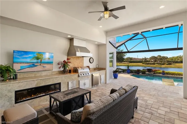 a living room with furniture a fireplace and garden view