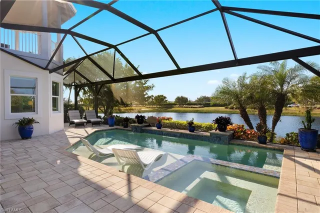 a view of swimming pool with outdoor seating and a yard