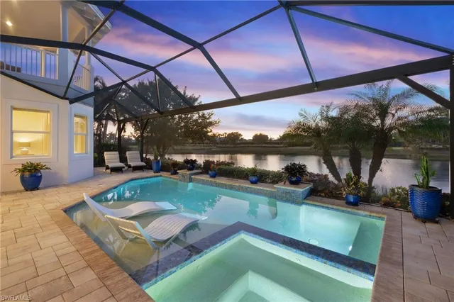 a spacious bedroom with a bed couch and a window