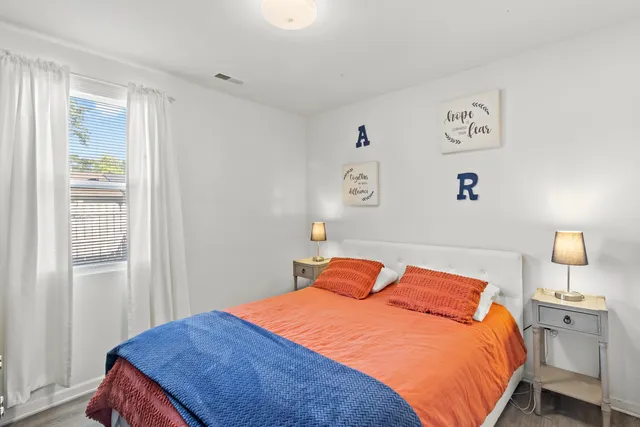 a bedroom with a bed and window