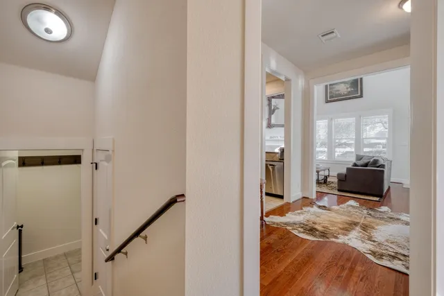 a view of a livingroom with wooden floor and a window