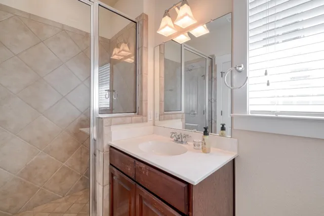 a bathroom with a sink vanity and a mirror