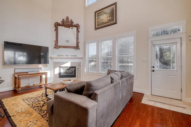 a living room with furniture fireplace and flat screen tv