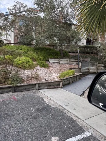 a view of a swimming pool with a yard and plants