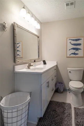 a bathroom with a double vanity sink mirror and toilet