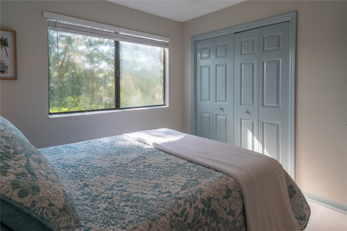 2582 Forest Ridge Drive, Unit N2 Fernandina Beach, FL 32034 - Photo 15 of 30 a bedroom with a bed and wooden floor
