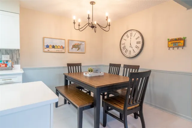 a view of a dining room with furniture and wall paintings