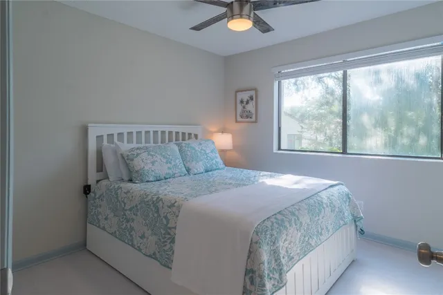 a bedroom with a bed and window