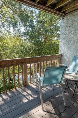a view of balcony with wooden floor and outdoor seating
