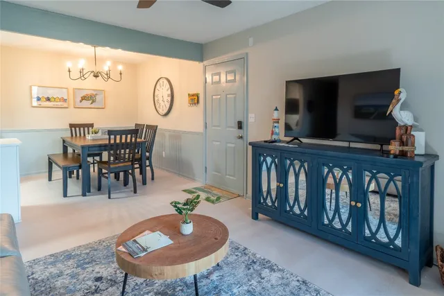 a living room with furniture a rug and a flat screen tv