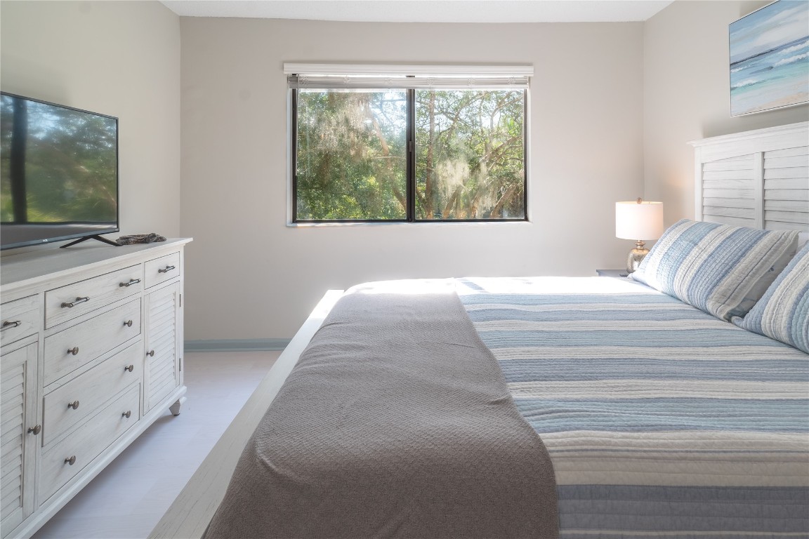 2582 Forest Ridge Drive, Unit N2 Fernandina Beach, FL 32034 - Photo 24 of 30 a bedroom with a bed and a flat screen tv