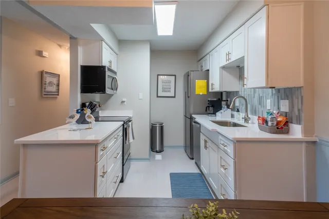 a kitchen with a sink and cabinets
