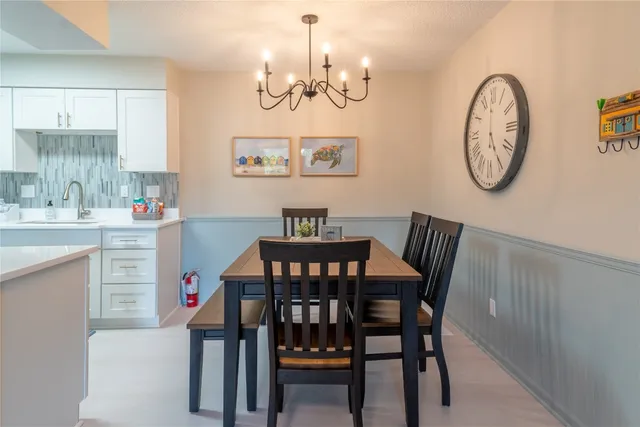 a view of a dining room with furniture and a chandelier