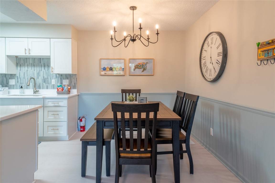 2582 Forest Ridge Drive, Unit N2 Fernandina Beach, FL 32034 - Photo 7 of 30 a view of a dining room with furniture and a chandelier