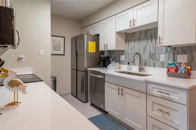 a kitchen with a sink appliances and cabinets