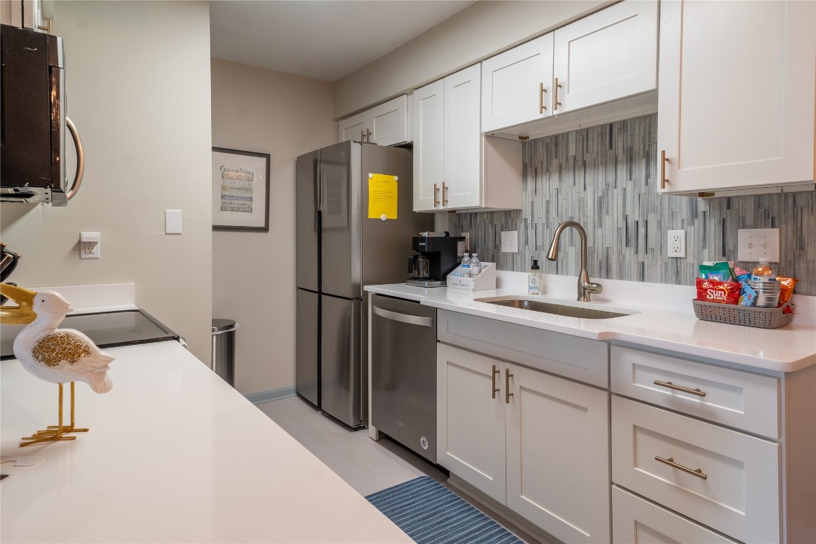 2582 Forest Ridge Drive, Unit N2 Fernandina Beach, FL 32034 - Photo 10 of 30 a kitchen with a sink appliances and cabinets