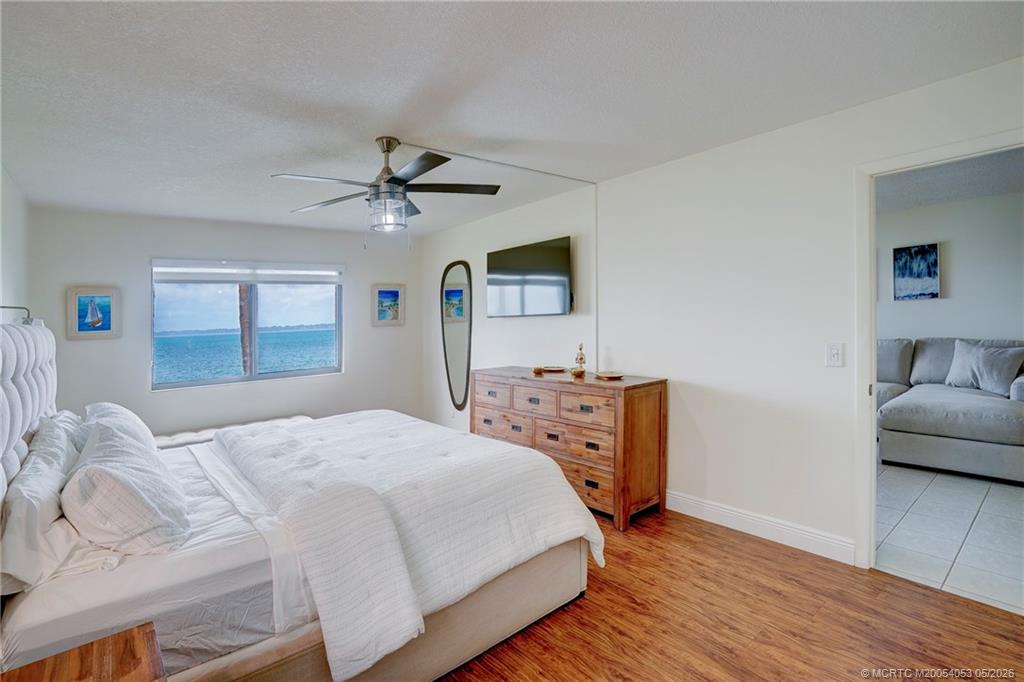 10 Northeast Plantation Road, Unit 101 Jensen Beach, FL 34957 - Photo 15 of 53 a bedroom with a bed and a couch