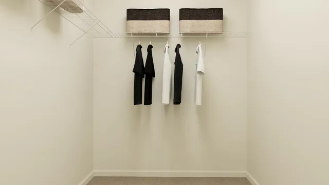 a view of walk in closet with clothes