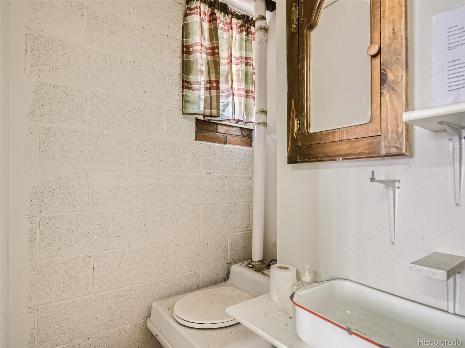 105 Royal Lane Bailey, CO 80421 - Photo 6 of 11 a bathroom with a sink a toilet and tub