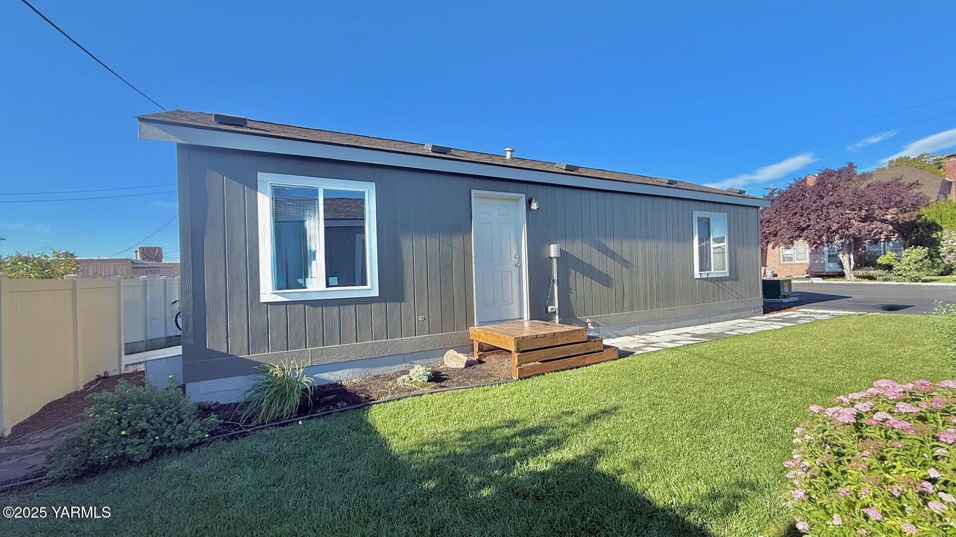 1418 Hathaway Street, Unit 24A Yakima, WA 98902 - Photo 3 of 12 a front view of a house with a yard