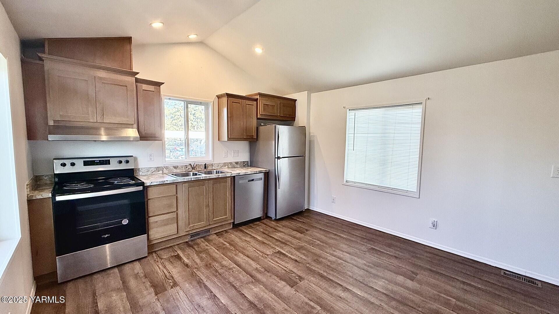 1418 Hathaway Street, Unit 24A Yakima, WA 98902 - Photo 5 of 12 a kitchen with stainless steel appliances a refrigerator and a stove top oven