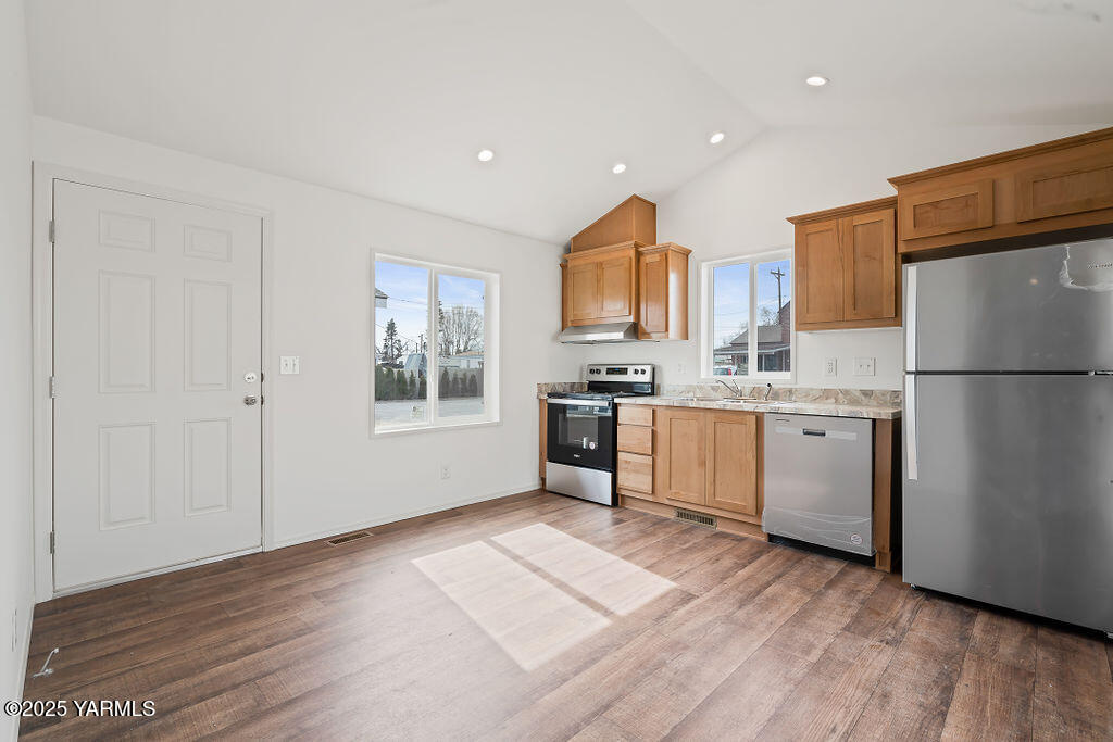1418 Hathaway Street, Unit 24A Yakima, WA 98902 - Photo 7 of 12 a kitchen with white cabinets and wooden floor