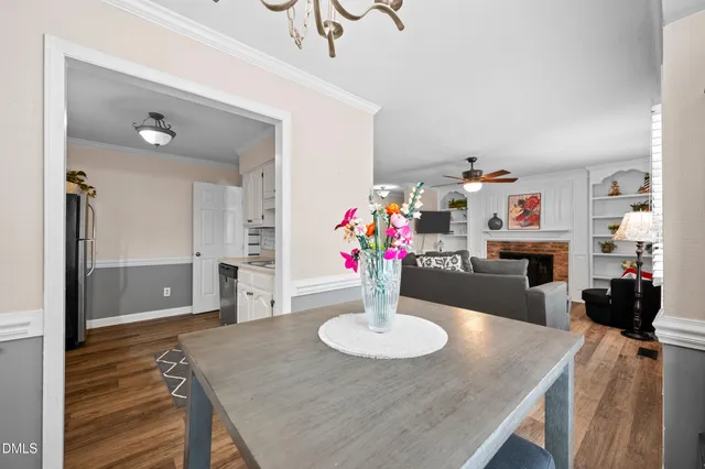 a view of a dining room with furniture and a chandelier