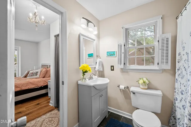 a bathroom with a granite countertop sink a large mirror and a shower