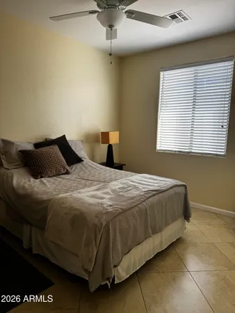 a bedroom with a bed and window