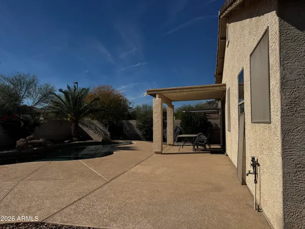 a view of a two chair and tables in patio of the house