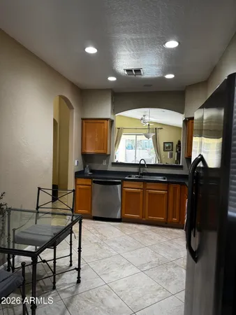 a kitchen with stainless steel appliances granite countertop counter space and breakfast area