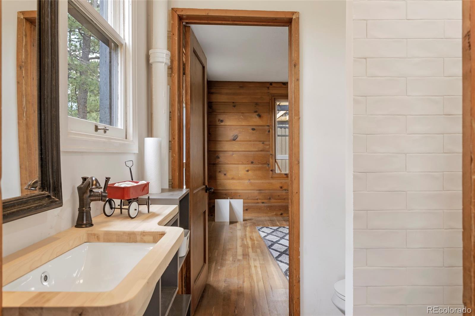 34200 Sioux Trail Pine, CO 80470 - Photo 21 of 37 a bathroom with a tub sink and mirror