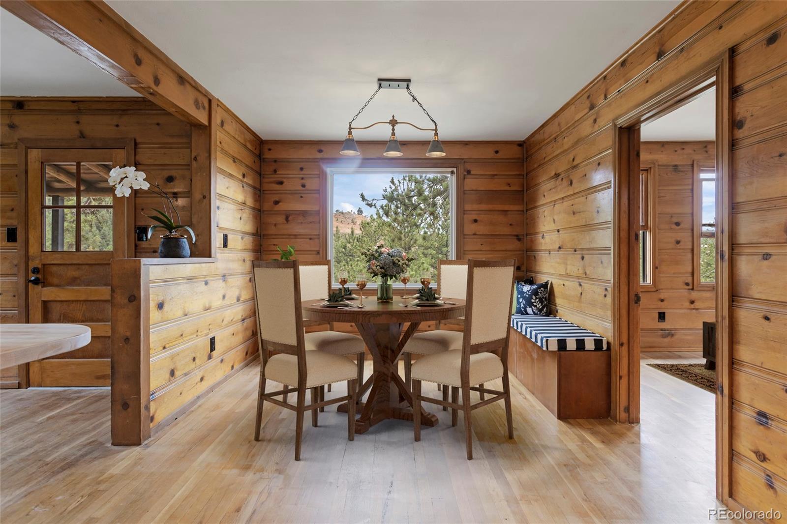 34200 Sioux Trail Pine, CO 80470 - Photo 7 of 37 a view of a dining room with furniture window and wooden floor