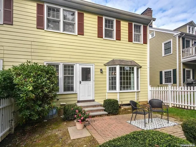 a view of a house with a chairs and a large window