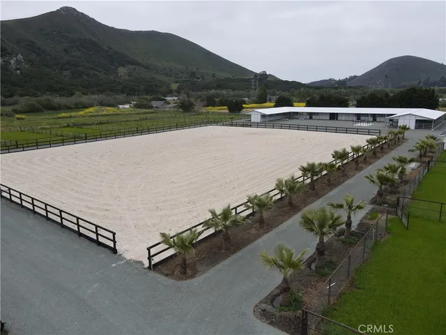 an aerial view of a house with a yard and lake view