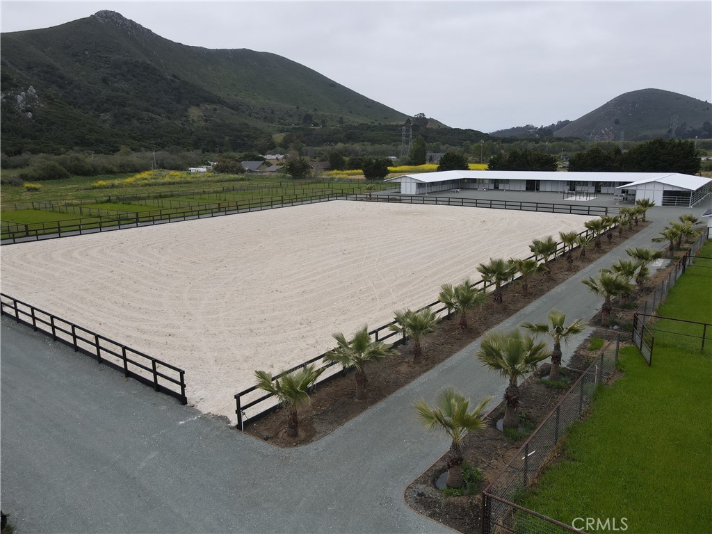 an aerial view of a house with a yard and lake view