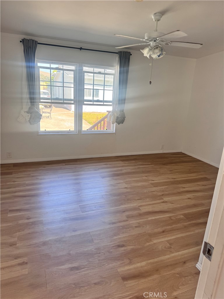 1970 Quintana Road Morro Bay, CA 93442 - Photo 20 of 38 an empty room with wooden floor and windows
