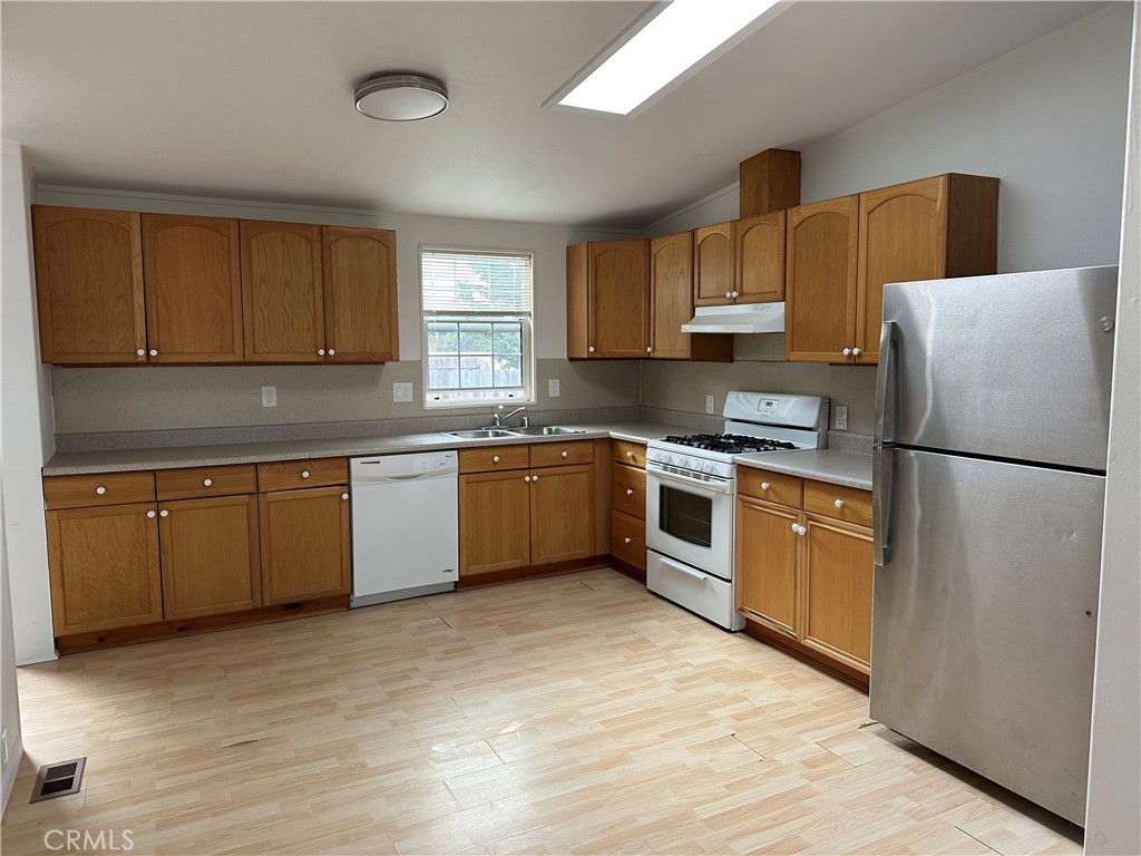 1970 Quintana Road Morro Bay, CA 93442 - Photo 36 of 38 a kitchen with stainless steel appliances granite countertop a refrigerator sink and cabinets