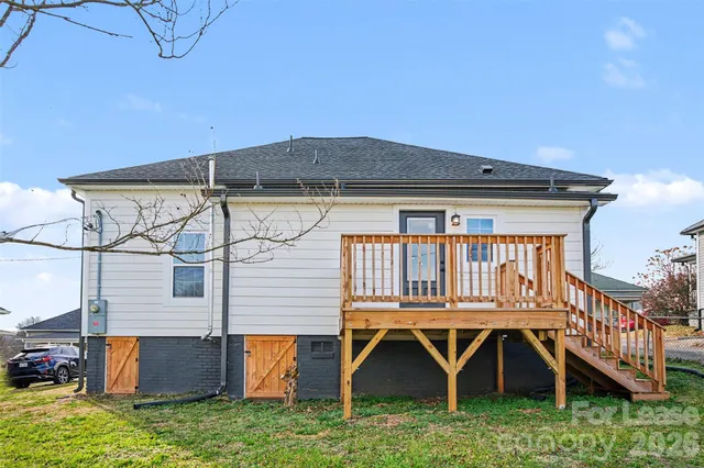 a backyard of a house with wooden floor and fence