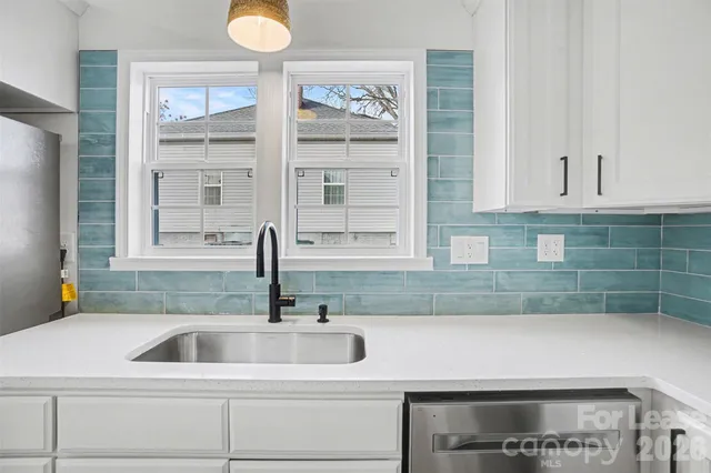a kitchen with a sink and cabinets