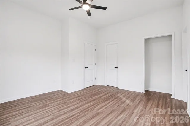 a view of a room with wooden floor