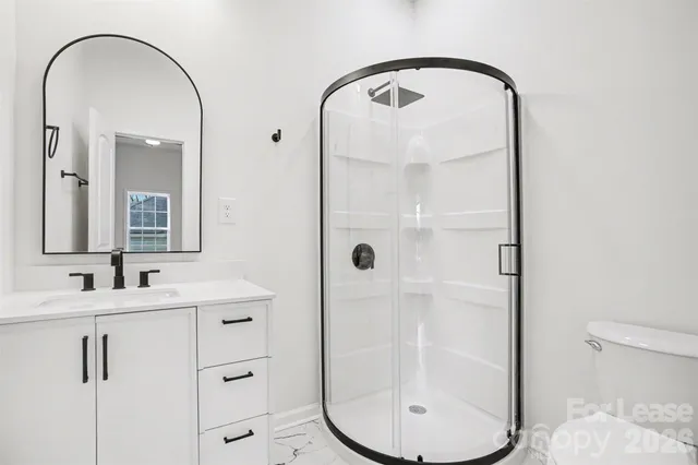 a bathroom with a sink a toilet and a mirror