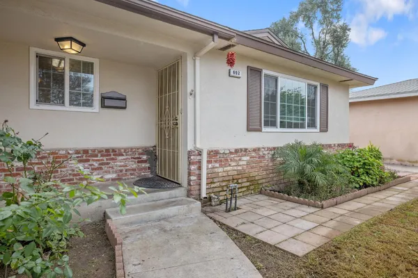 a living room with furniture a ceiling fan and a rug