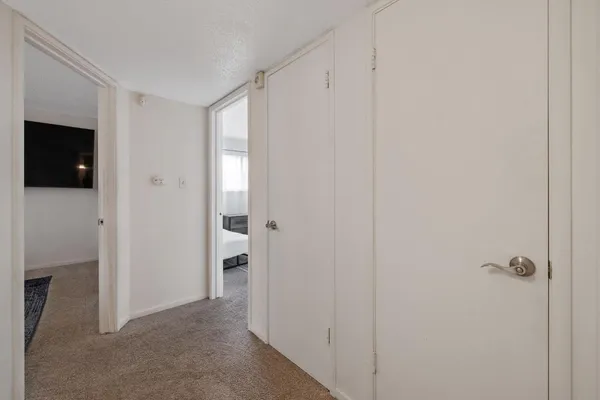 a view of an empty room with a hallway